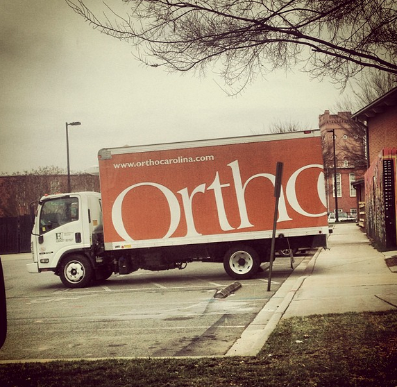 Random trucks all over Charlotte are wrapped in the OrthoCarolina logo.
