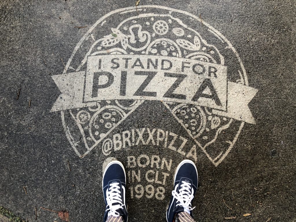 reverse graffiti of a pizza on the sidewalk for Brixx Pizza
