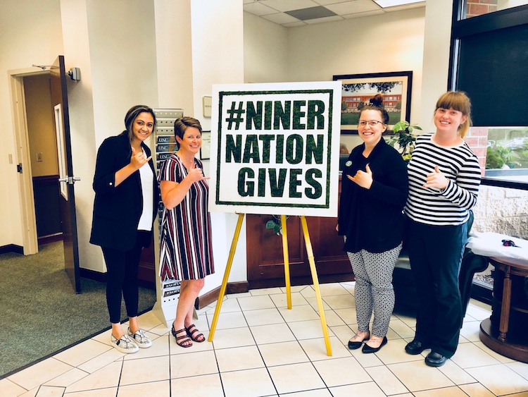 Four women with the Niner Nation Gives Moss Art.