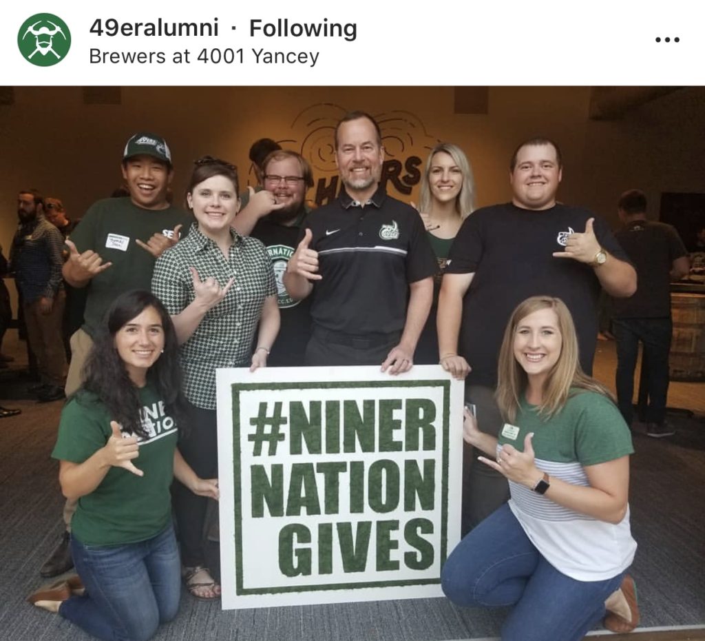 Smiling group with the Niner Nation Gives