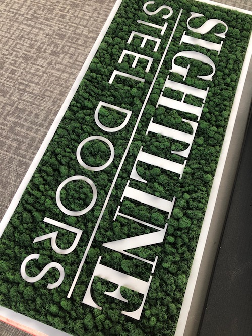 Overhead angle of the forest green preserved Moss Art piece for Sightline Steel Doors.