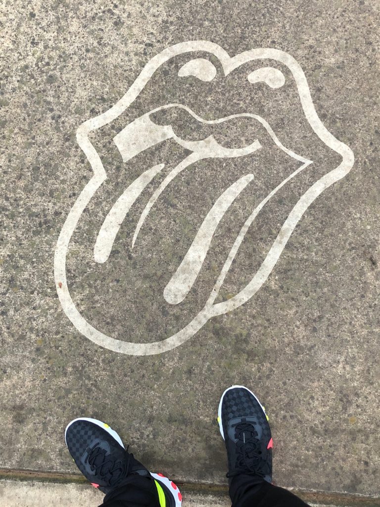 A man wearing Nikes poses with a Rolling Stones Clean Graffiti spot in Charlotte, NC