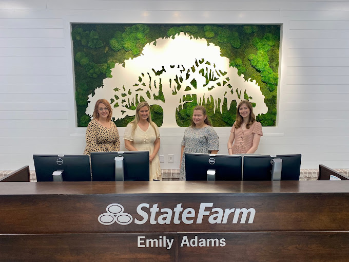The Emily Adams State Farm Insurance Team in front of the green Moss Wall created by The Savage Way.