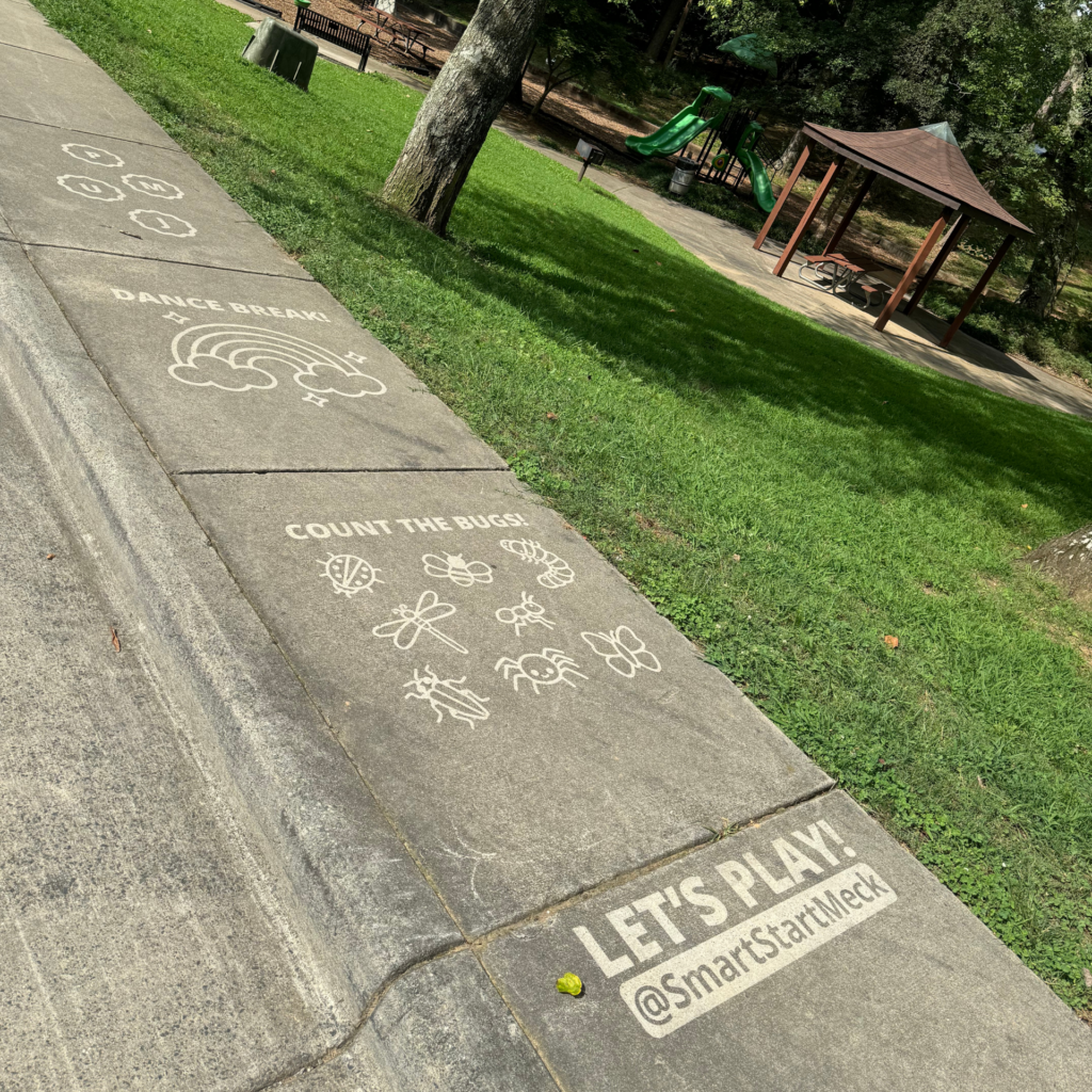 Smart Start of Meklenburg County hired The Savage Way to pressure wash a kids game on the sidewalk near a park in Charlotte, NC. "Count the Bugs," "Danece Break," "JUMP," "Let's Play" are interactive and free for families. 